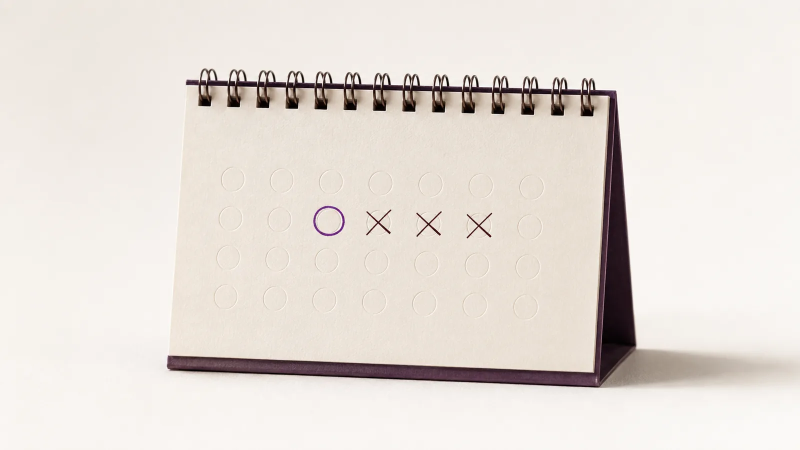 A desk calendar with one date circled and the following days crossed out.