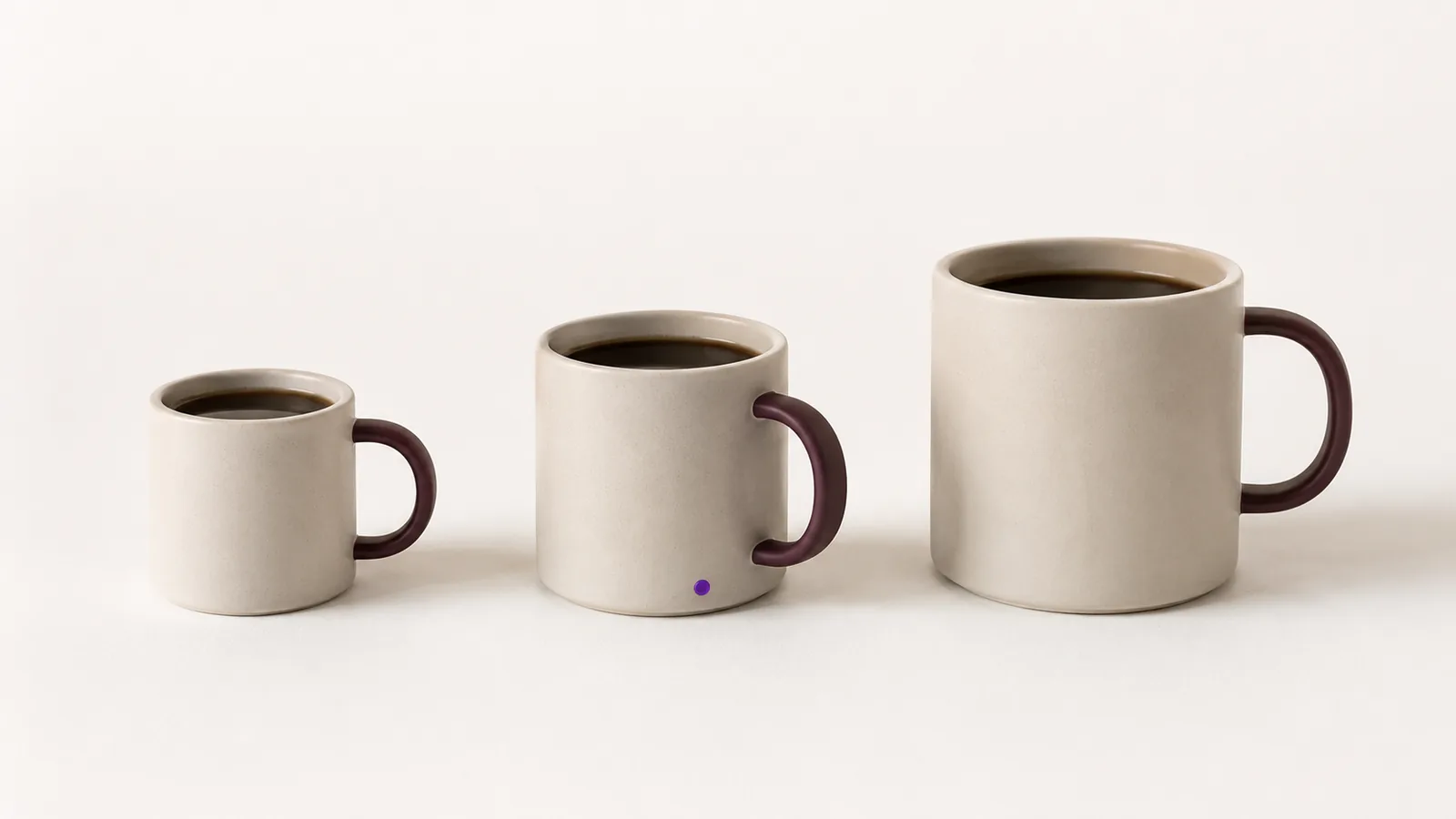 Three identical coffee cups in a row, small, medium and large.