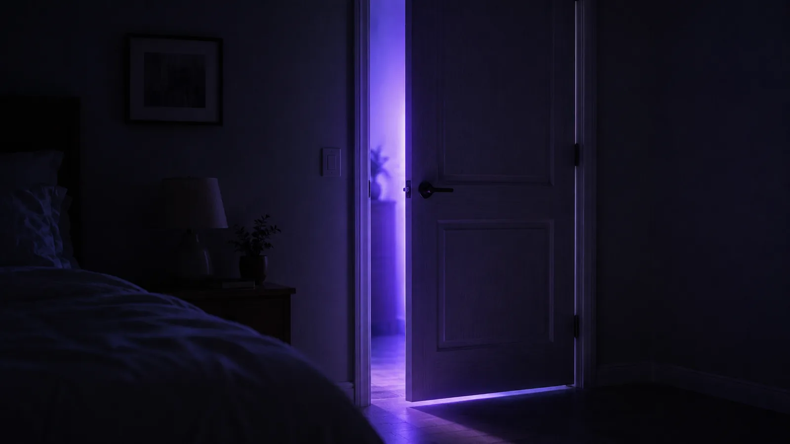 A bedroom door ajar with unnaturally violet light coming through the gap.